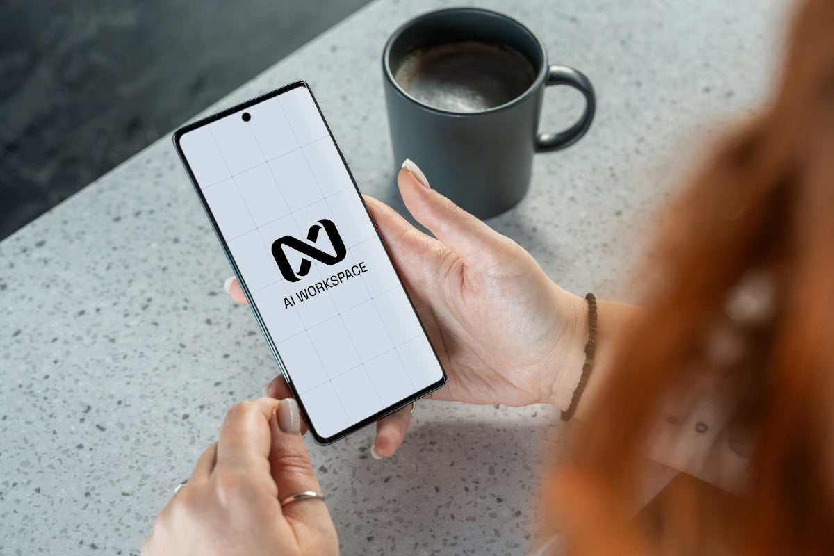 Woman holding smartphone with ai workspace logo.